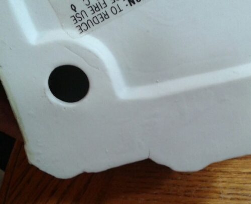 A close up of the bottom of a white plastic container.